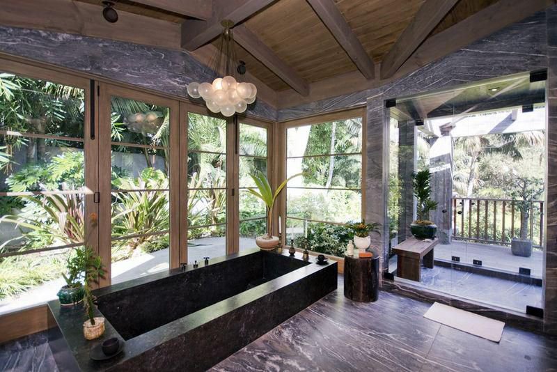 Spa-inspired bathroom featuring a soaking tub, garden views, and natural finishes at a private Malibu estate.