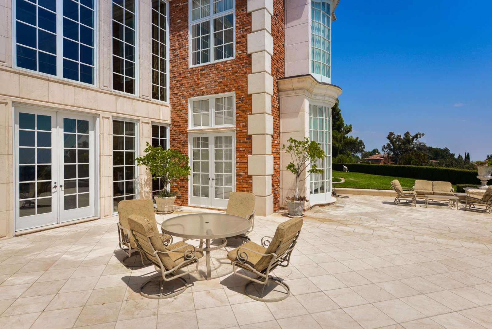 Expansive stone terrace overlooking the gardens at a classic Pasadena estate, ideal for cocktail receptions and outdoor entertaining.