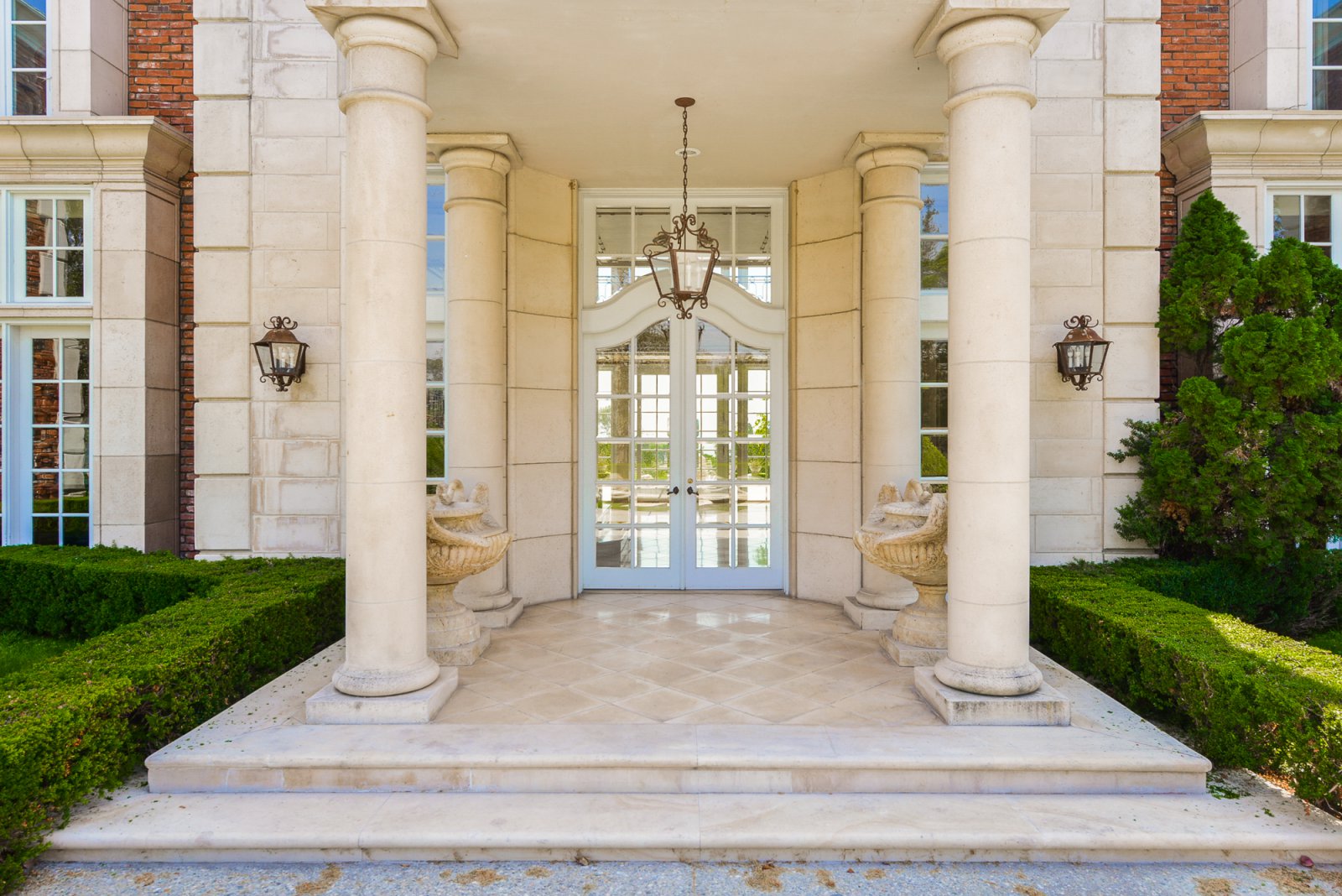 Grand columned entrance to a classic Pasadena estate with elegant limestone architecture and formal entryway for luxury weddings and private events.