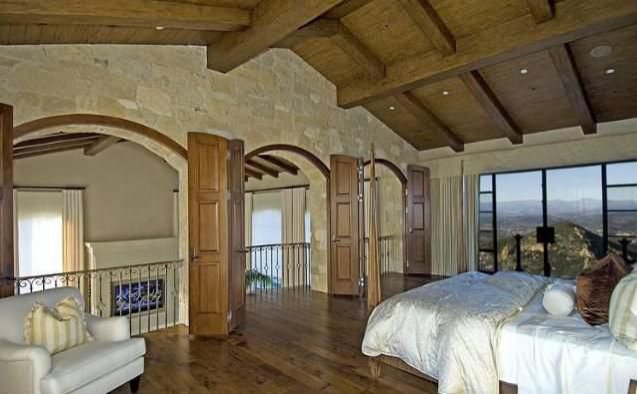 Private primary suite with mountain views and elegant Tuscan-inspired architecture.