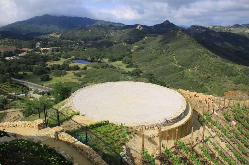 Private helicopter landing pad overlooking vineyards and panoramic mountain views at a luxury Malibu vineyard estate.