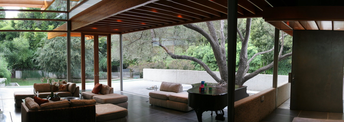 John Lautner living room with floor-to-ceiling glass walls opening to a private terrace