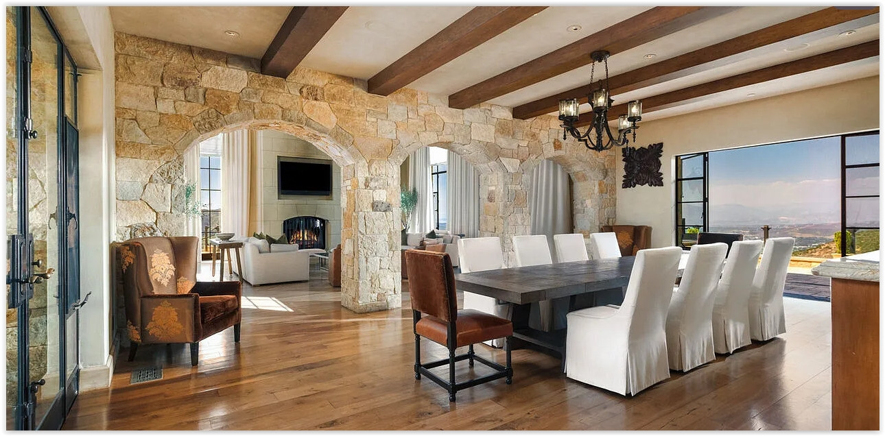 Elegant formal dining room with exposed wood beams and spectacular mountain views.