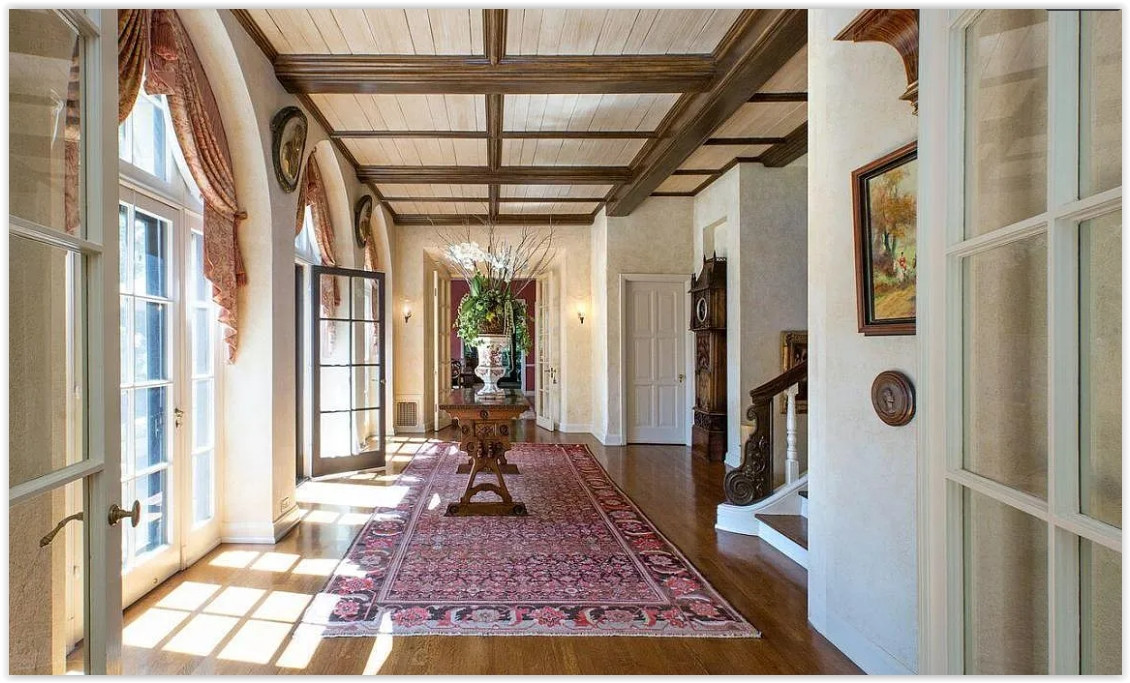 Grand interior hallway with wood-beamed ceilings and classic architectural details inside a Pasadena estate.
