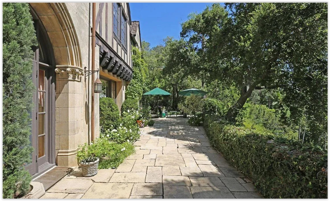 Peaceful garden pathway beneath mature oak trees at a private Pasadena estate.