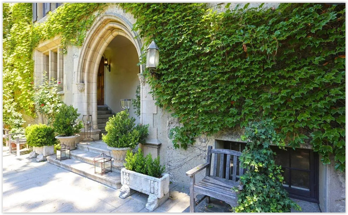 Ivy-covered stone entrance with Gothic archway at a private Pasadena estate, creating a romantic setting for intimate gatherings and luxury photo shoots.