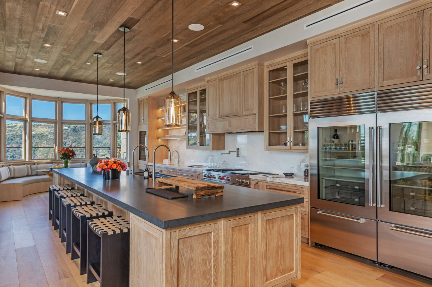 Modern gourmet kitchen with a large center island, premium appliances, and open entertaining design.