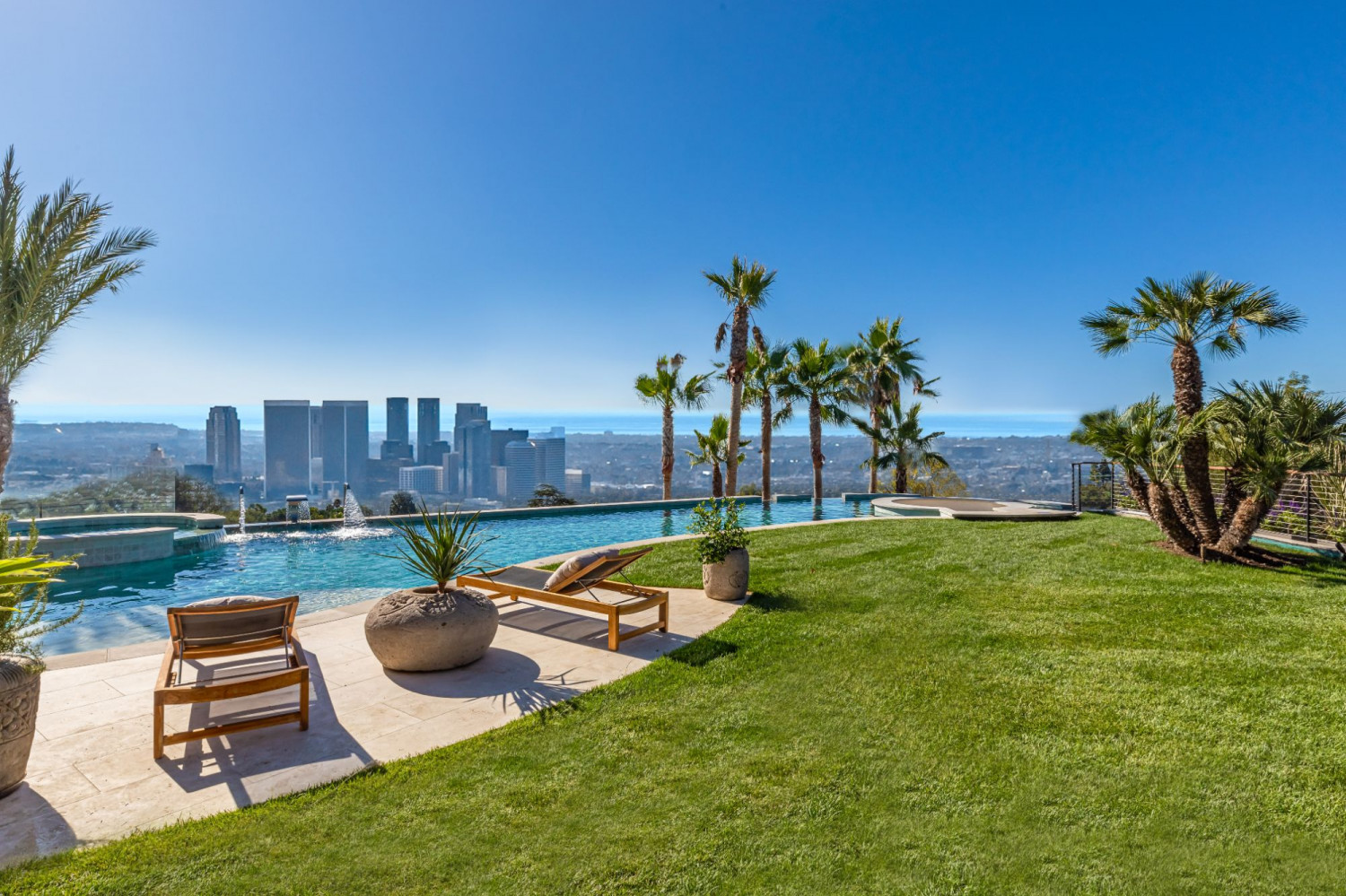 Contemporary pool overlooking the hills of Beverly Hills with luxury outdoor entertaining space.