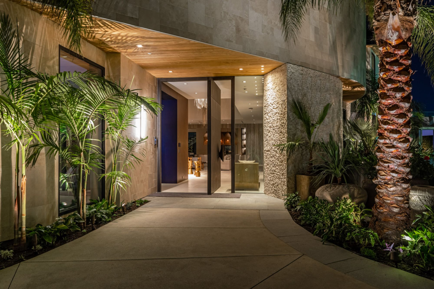 Modern Beverly Hills home with clean architectural lines, floor-to-ceiling glass, and luxury landscaping.