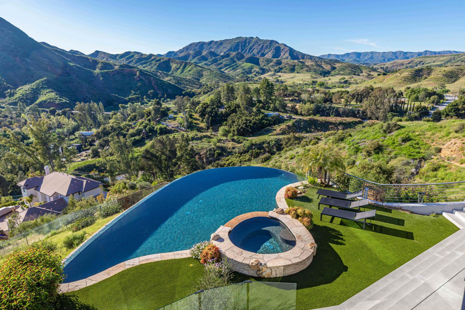 Luxury hillside estate pool overlooking canyon landscape in Agoura Hills with modern architecture and resort-style outdoor design.
