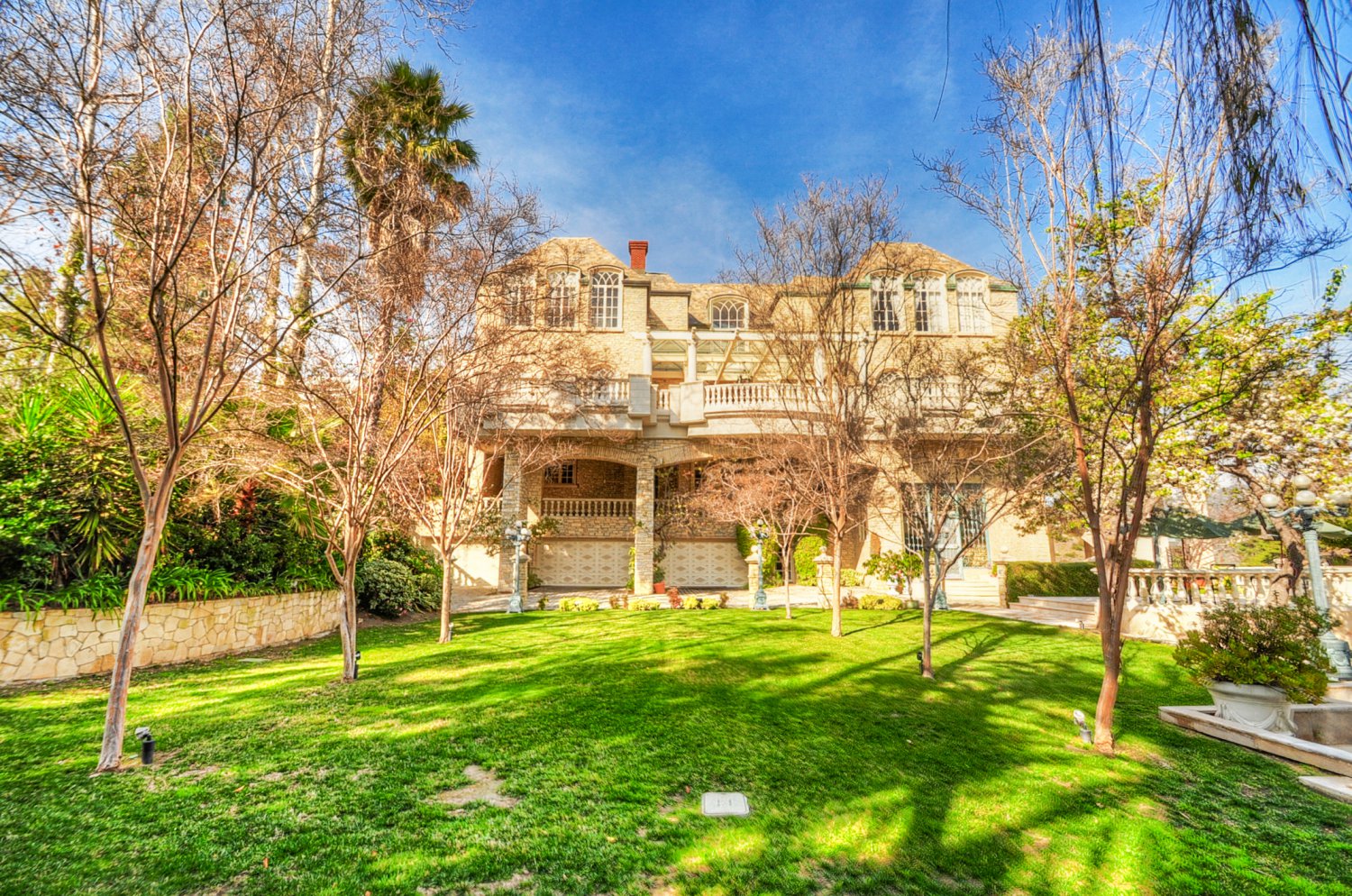 Expansive rear lawn at a luxury Beverly Hills estate rental with European-inspired architecture | D645-BH