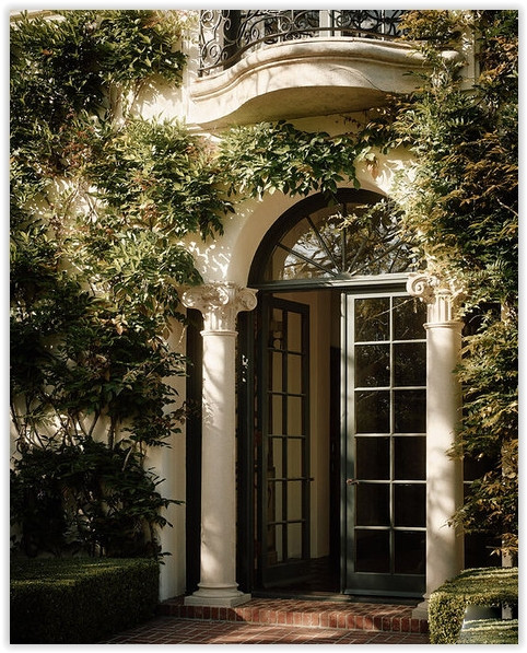 Ornate arched doorway surrounded by greenery at C199-BA Bel Air estate