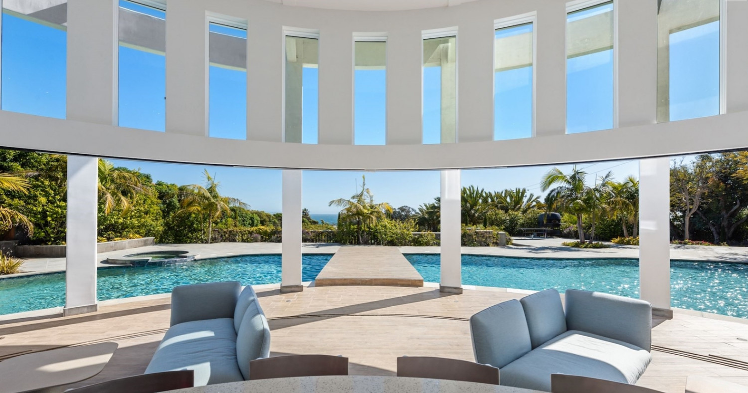 Interior of the circular pool pavilion overlooking the resort-style pool and ocean at a luxury Malibu estate.